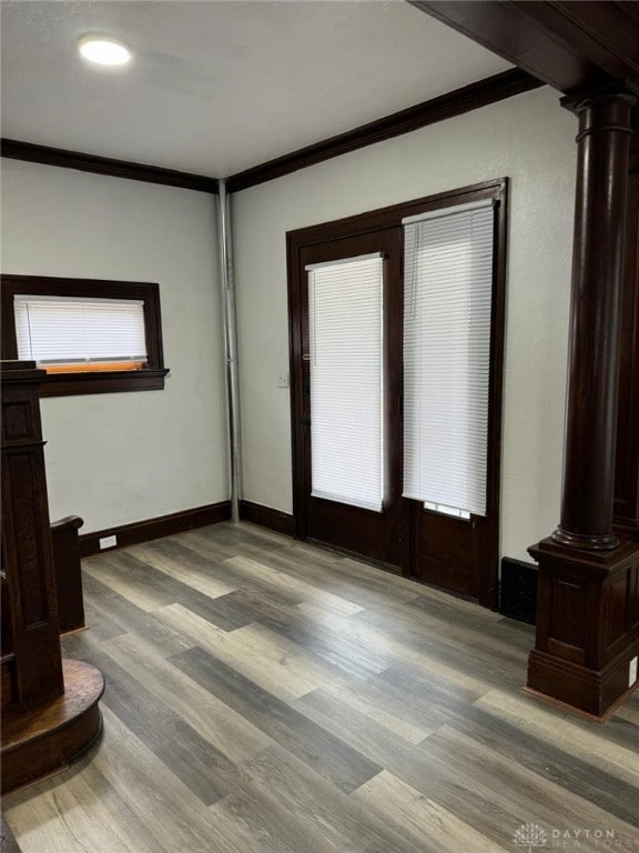 2312 Parkland Ave, Dayton, OH 45405 - unfurnished room featuring decorative columns, ornamental molding, baseboards, and wood finished floors