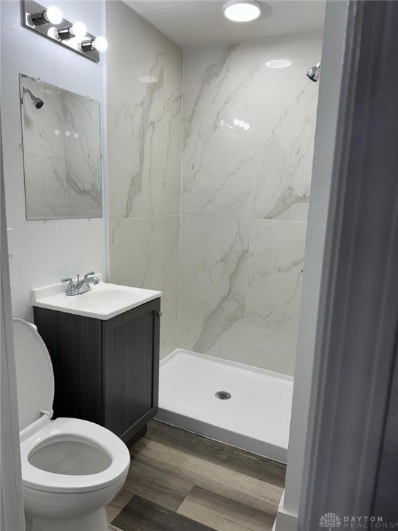 2312 Parkland Ave, Dayton, OH 45405 - full bathroom featuring toilet, wood finished floors, vanity, and a marble finish shower