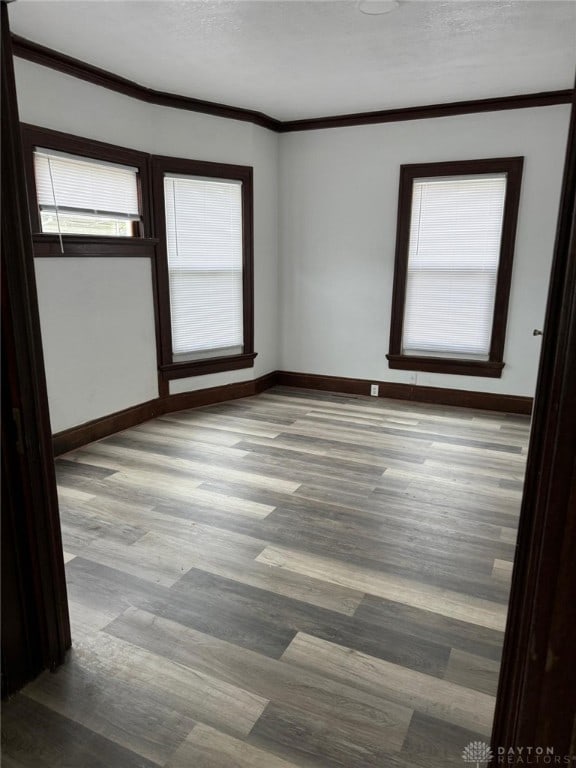 2312 Parkland Ave, Dayton, OH 45405 - unfurnished room with baseboards, crown molding, and wood finished floors