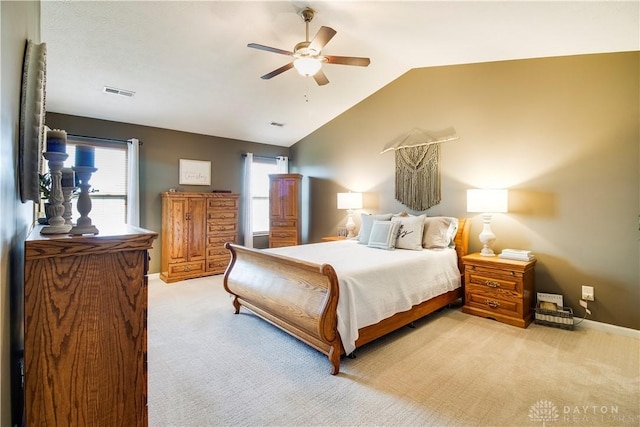 bedroom featuring ceiling fan, visible vents, vaulted ceiling, light carpet, and baseboards