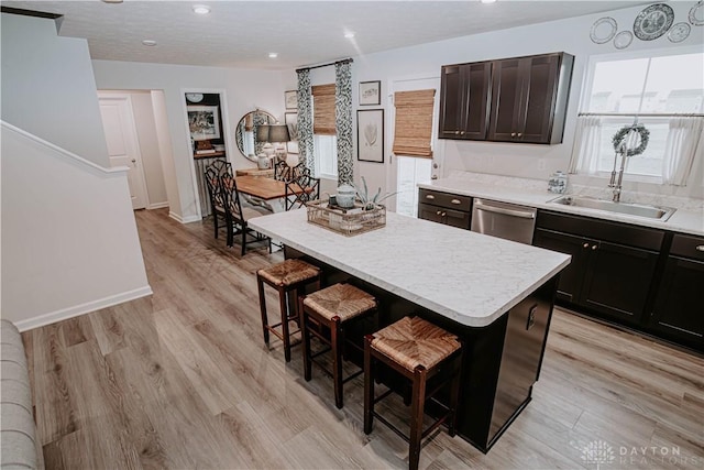 4249 Willow Hills Dr, Dayton, OH 45404 - kitchen featuring dishwasher, a kitchen breakfast bar, light countertops, a center island, and recessed lighting