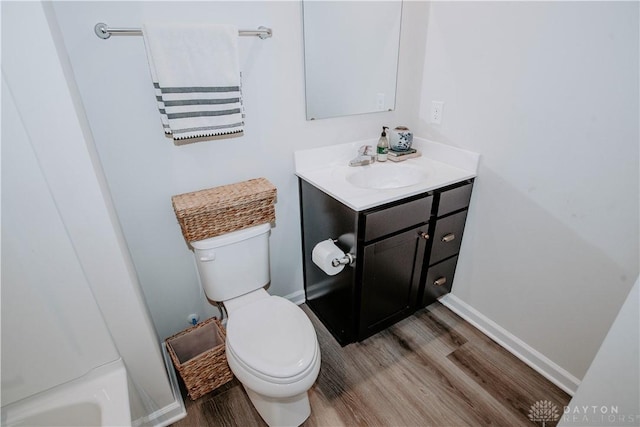 4249 Willow Hills Dr, Dayton, OH 45404 - bathroom featuring wood finished floors, toilet, vanity, and baseboards