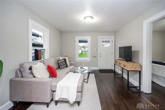 living room featuring baseboards and dark wood finished floors