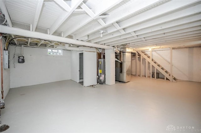 below grade area with electric panel, water heater, and heating unit