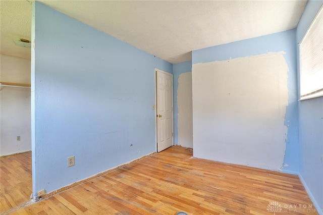 spare room with hardwood / wood-style floors