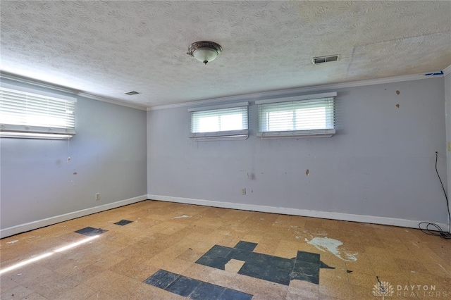 empty room featuring baseboards, visible vents, and tile patterned floors