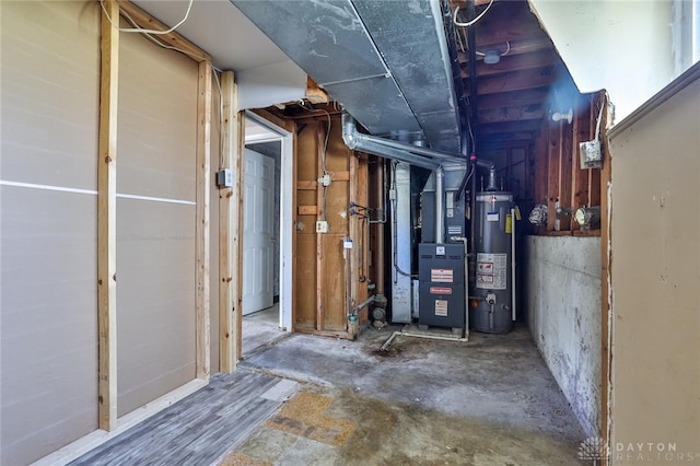 utility room with heating unit and water heater