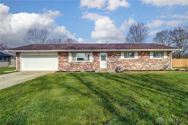 ranch-style home with fence, a front lawn, brick siding, a garage, and driveway