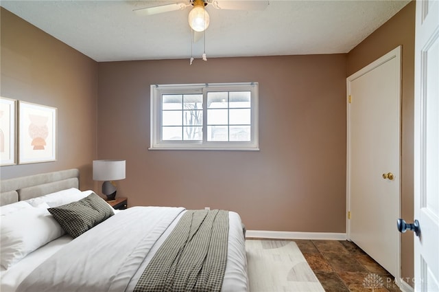 bedroom featuring baseboards and a ceiling fan