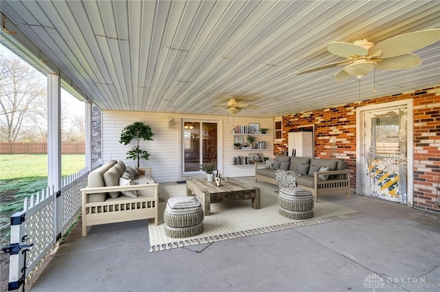 view of patio featuring fence, an outdoor hangout area, and a ceiling fan