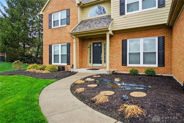433 Vincent Ct, Middletown, OH 45042 - property entrance featuring brick siding, a lawn, and a shingled roof