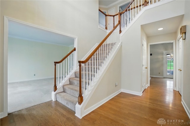 433 Vincent Ct, Middletown, OH 45042 - staircase with wood finished floors, baseboards, a towering ceiling, and crown molding