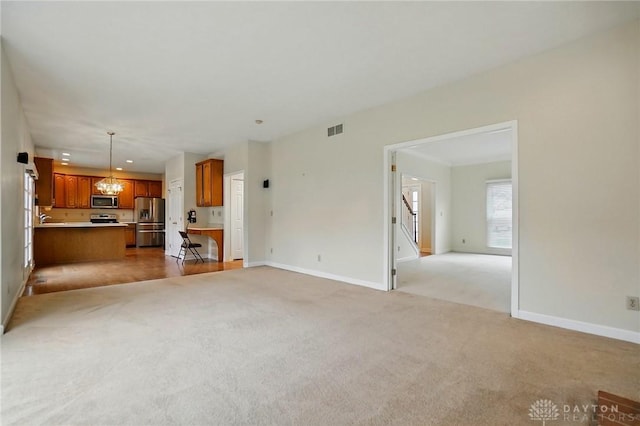 433 Vincent Ct, Middletown, OH 45042 - unfurnished living room featuring light colored carpet, baseboards, stairway, and recessed lighting
