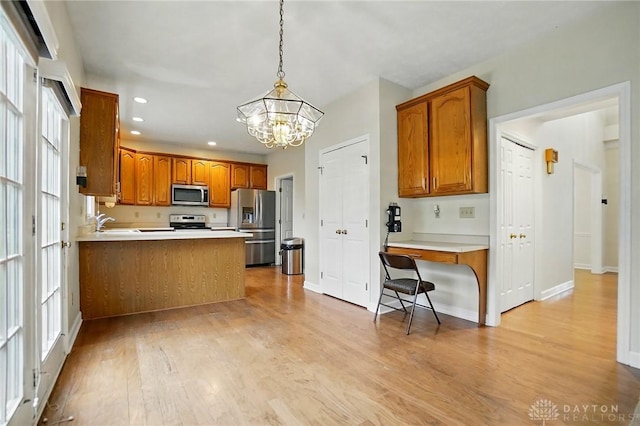 433 Vincent Ct, Middletown, OH 45042 - kitchen featuring stainless steel appliances, a chandelier, light wood-style flooring, brown cabinets, and recessed lighting