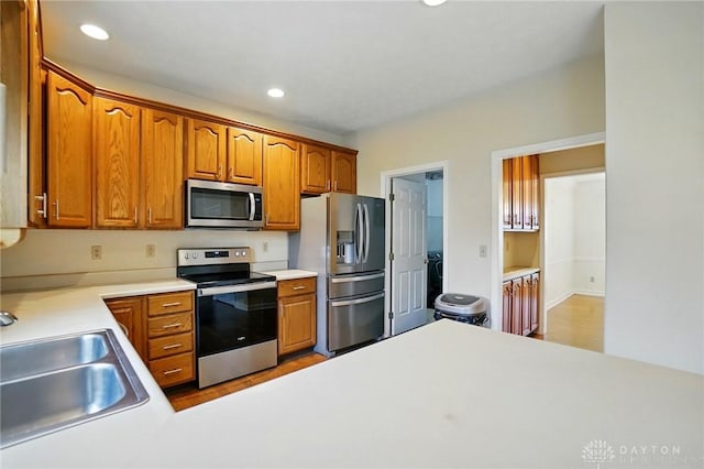 433 Vincent Ct, Middletown, OH 45042 - kitchen with stainless steel appliances, a sink, light countertops, recessed lighting, and wood finished floors