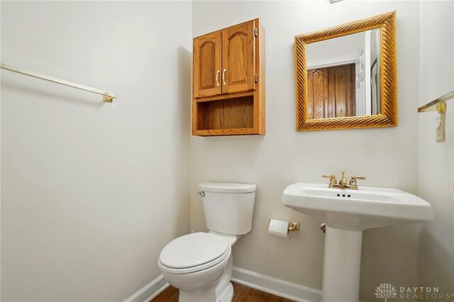 433 Vincent Ct, Middletown, OH 45042 - bathroom with baseboards, toilet, and wood finished floors