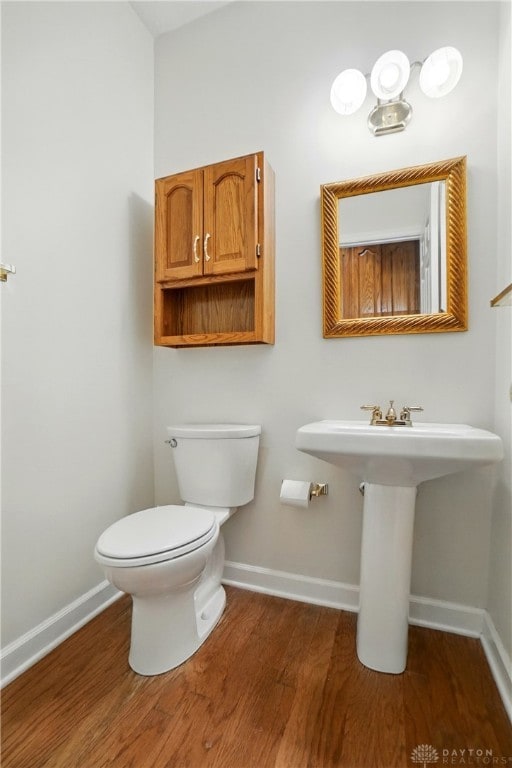 433 Vincent Ct, Middletown, OH 45042 - half bathroom featuring baseboards, wood finished floors, and toilet