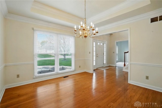 433 Vincent Ct, Middletown, OH 45042 - unfurnished dining area featuring a chandelier, healthy amount of natural light, wood finished floors, a raised ceiling, and ornamental molding