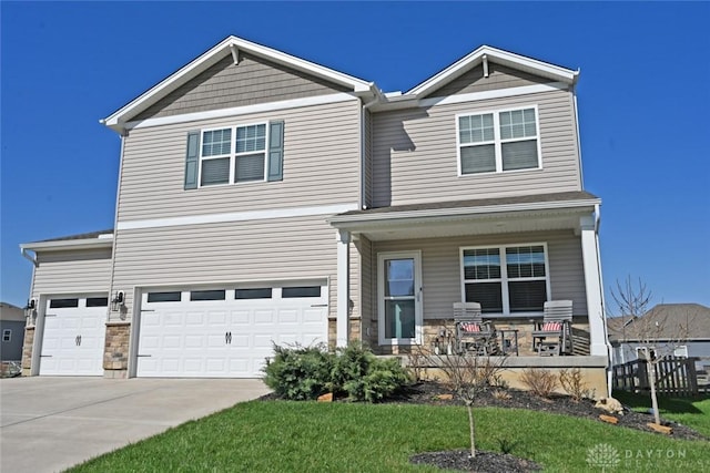 craftsman house featuring driveway, covered porch, a garage, and stone siding