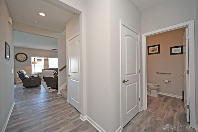 hall featuring wood finished floors and baseboards