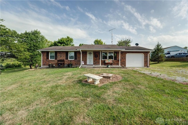 single story home with a garage, a front yard, brick siding, and driveway