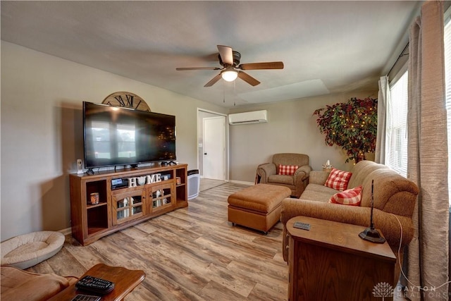 living area featuring a wall unit AC, a ceiling fan, and wood finished floors