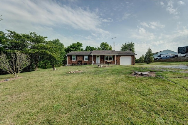 single story home with an attached garage, a front lawn, and brick siding