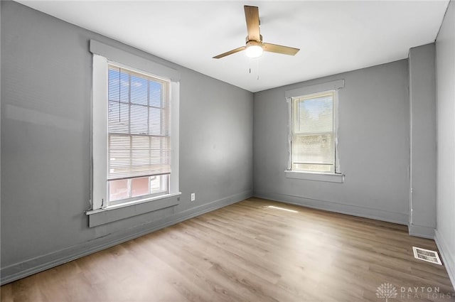 578 Wyoming St, Dayton, OH 45410 - empty room with visible vents, baseboards, a ceiling fan, and wood finished floors