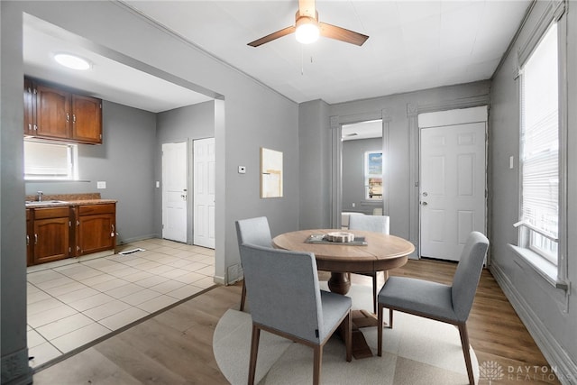 578 Wyoming St, Dayton, OH 45410 - dining area with light wood-style floors, a ceiling fan, and a healthy amount of sunlight