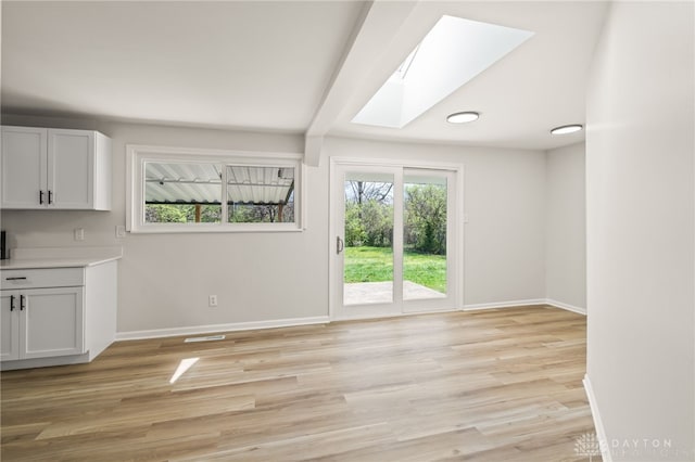 4433 Lambeth Dr, Dayton, OH 45424 - interior space featuring a skylight, baseboards, and light wood finished floors