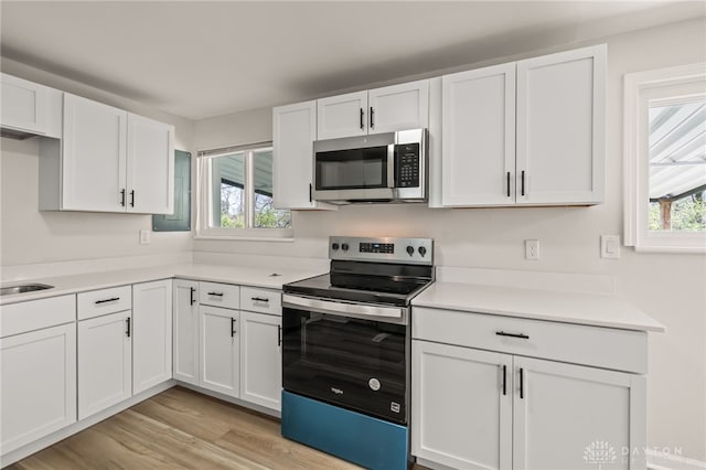 4433 Lambeth Dr, Dayton, OH 45424 - kitchen with light countertops, appliances with stainless steel finishes, light wood-style flooring, and white cabinetry
