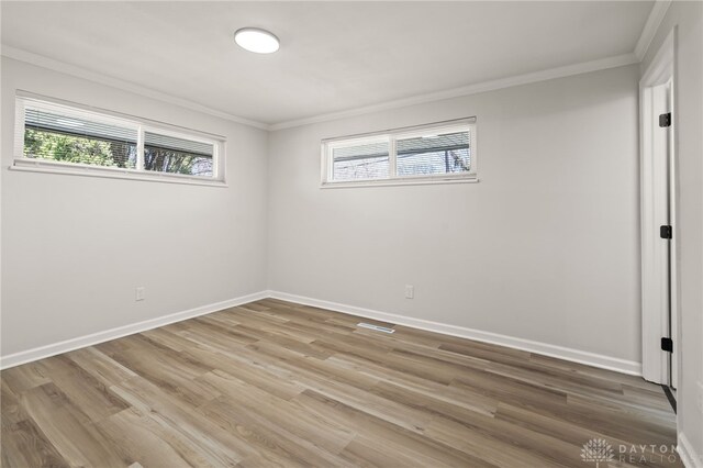 4433 Lambeth Dr, Dayton, OH 45424 - unfurnished room with crown molding, wood finished floors, and a healthy amount of sunlight