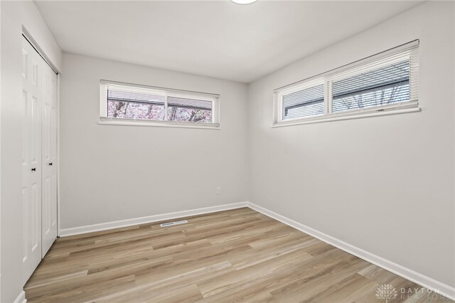 4433 Lambeth Dr, Dayton, OH 45424 - unfurnished bedroom with baseboards, visible vents, light wood-type flooring, and a closet