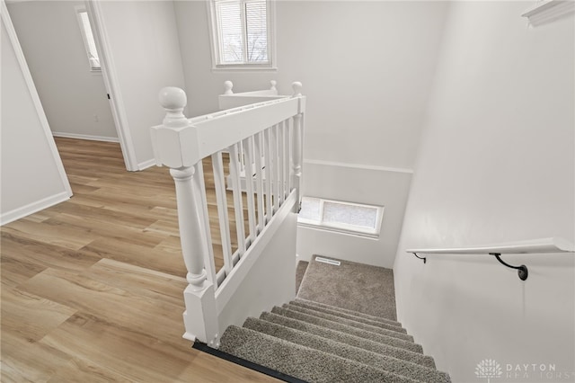 4433 Lambeth Dr, Dayton, OH 45424 - stairway featuring baseboards, wood finished floors, and visible vents