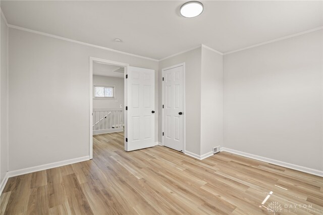 4433 Lambeth Dr, Dayton, OH 45424 - unfurnished bedroom with visible vents, ornamental molding, baseboards, and light wood finished floors
