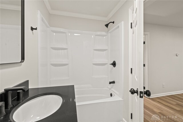 4433 Lambeth Dr, Dayton, OH 45424 - full bath featuring crown molding, a sink, shower / bathtub combination, baseboards, and wood finished floors