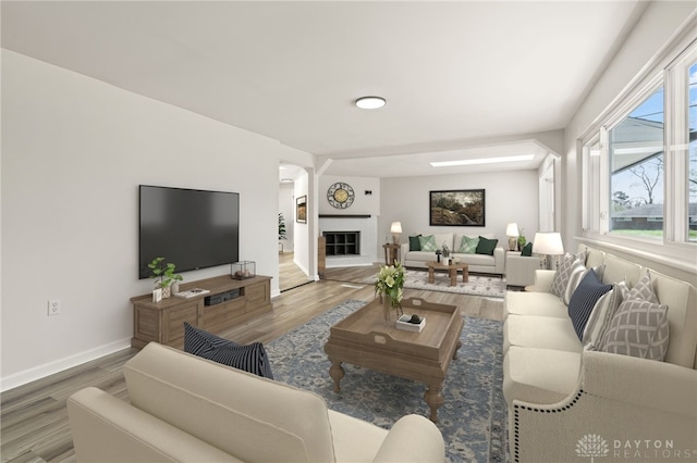 4433 Lambeth Dr, Dayton, OH 45424 - living room featuring a glass covered fireplace, baseboards, and wood finished floors