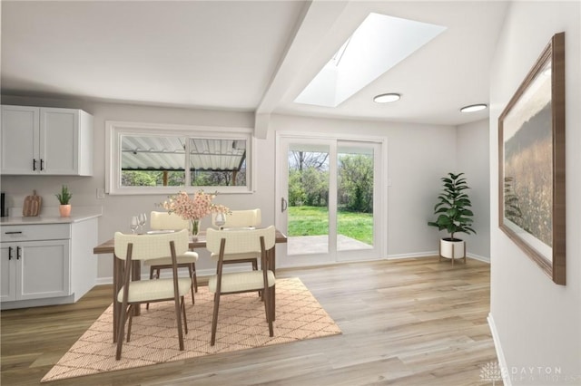 4433 Lambeth Dr, Dayton, OH 45424 - dining area with light wood-type flooring, baseboards, a wealth of natural light, and a skylight