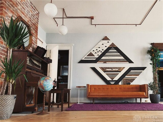 1400 E 3rd St, Dayton, OH 45403 - living area featuring wood finished floors and brick wall