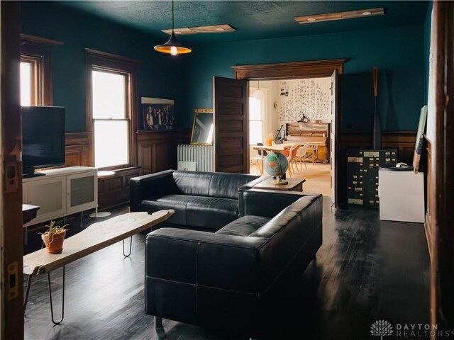 1400 E 3rd St, Dayton, OH 45403 - living area with a textured ceiling, a wainscoted wall, and wood finished floors