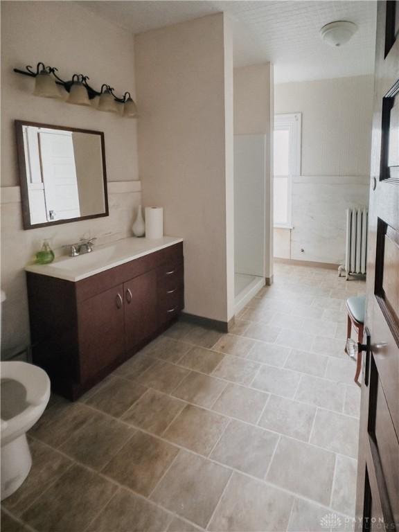1400 E 3rd St, Dayton, OH 45403 - bathroom featuring toilet, radiator heating unit, and vanity