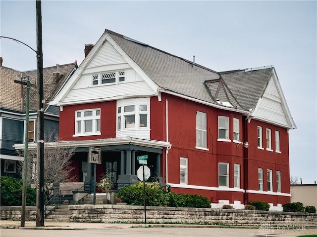 1400 E 3rd St, Dayton, OH 45403 - view of front of house with a chimney and covered porch