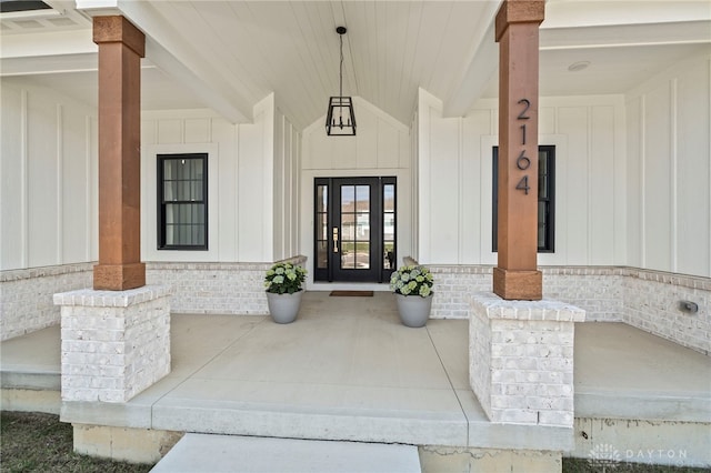 2164 Northbridge Trl, Troy, OH 45373 - entrance to property featuring a porch, board and batten siding, and brick siding