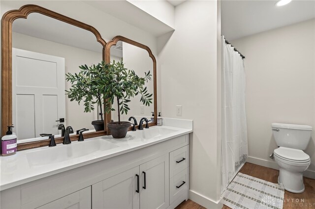 2164 Northbridge Trl, Troy, OH 45373 - full bath with toilet, wood finished floors, double vanity, baseboards, and recessed lighting