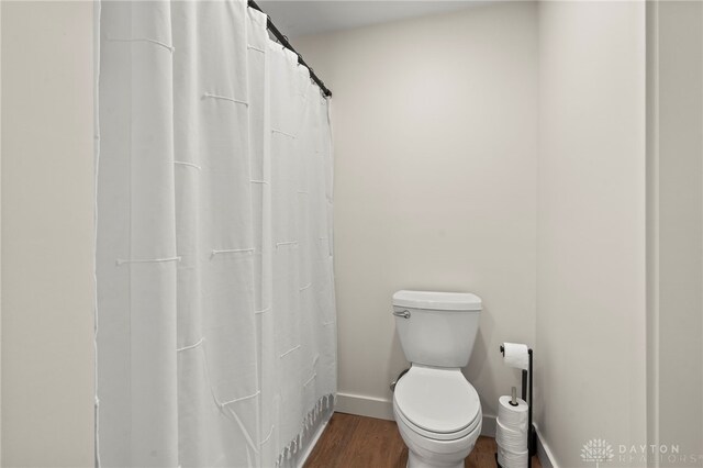 2164 Northbridge Trl, Troy, OH 45373 - full bath with wood finished floors, baseboards, toilet, and curtained shower