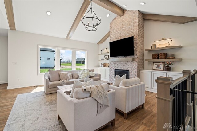2164 Northbridge Trl, Troy, OH 45373 - living room with a chandelier, wood finished floors, a brick fireplace, recessed lighting, and baseboards