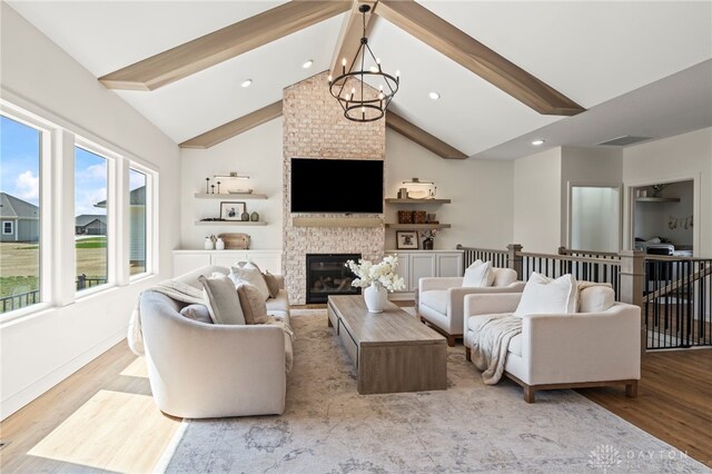 2164 Northbridge Trl, Troy, OH 45373 - living room featuring beamed ceiling, a chandelier, a fireplace, wood finished floors, and recessed lighting