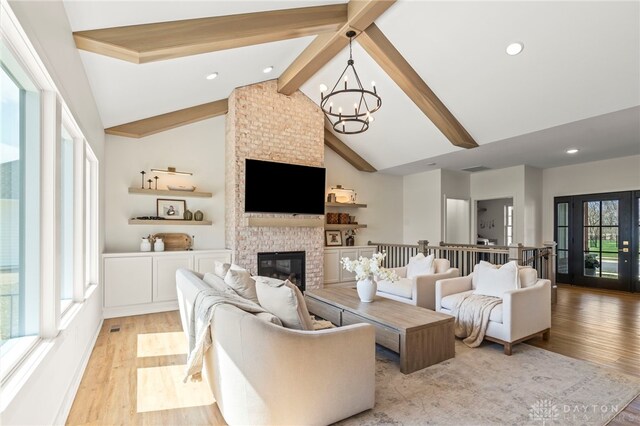 2164 Northbridge Trl, Troy, OH 45373 - living room featuring a chandelier, light wood-style floors, beam ceiling, a brick fireplace, and recessed lighting