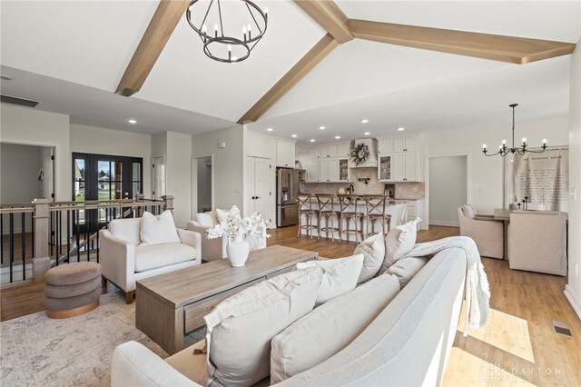 2164 Northbridge Trl, Troy, OH 45373 - living area featuring a chandelier, beam ceiling, high vaulted ceiling, light wood-style floors, and recessed lighting