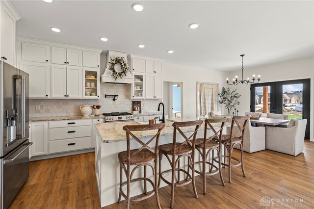 2164 Northbridge Trl, Troy, OH 45373 - kitchen featuring high end fridge, custom exhaust hood, range, wood finished floors, and recessed lighting